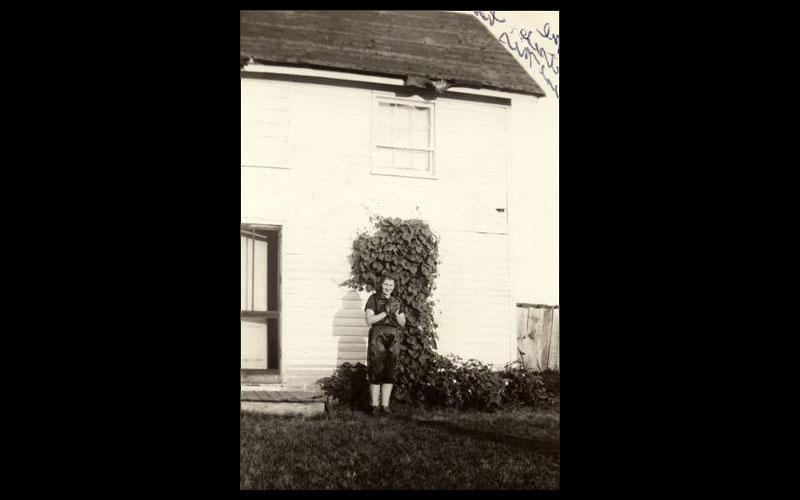 Jean, the Baseball Pitcher | Jean dressed in her high school baseball pitcher's uniform outside her Aunt Mi's house in Gentry County in the late 1930s.  (Courtesy of Jean JENNINGS Bartik Computing Museum)